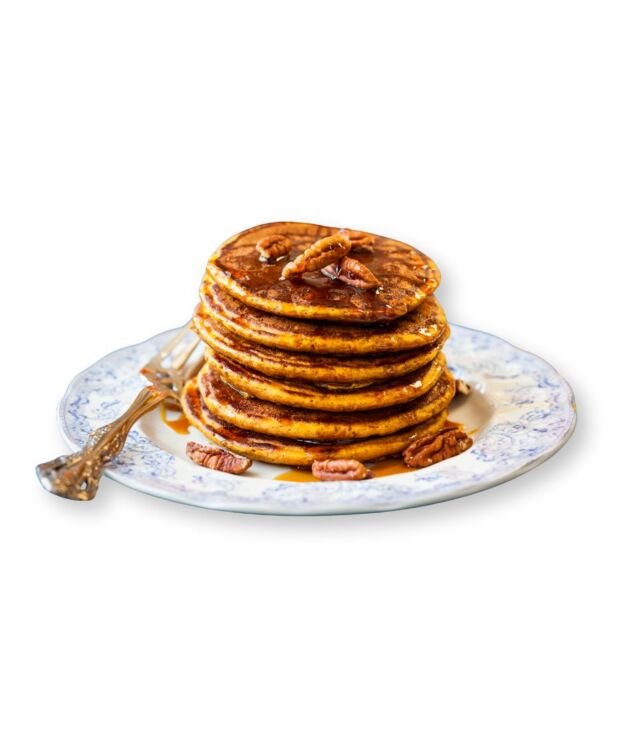 Pumpkin Pecan Pancakes topped with syrup and whipped cream at NY Diner Boston in Brighton MA