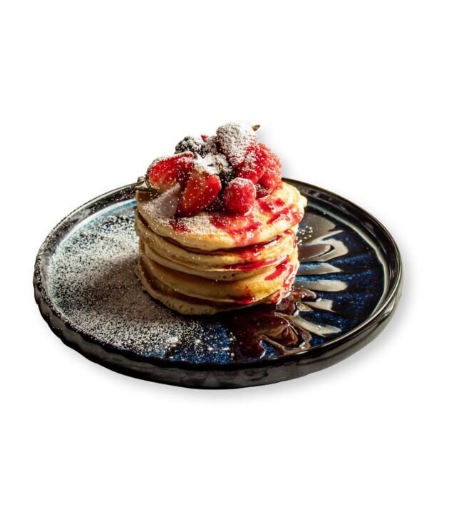 Strawberry Pancakes topped with whipped cream and syrup at NY Diner Boston in Brighton MA